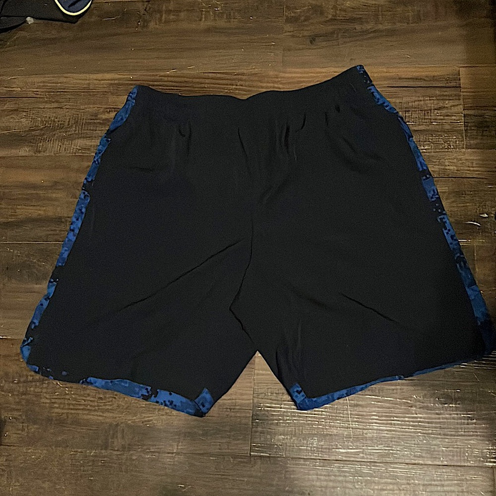 Dark blue and black Tapout athletic shorts. Large in Men’s with draw strings.